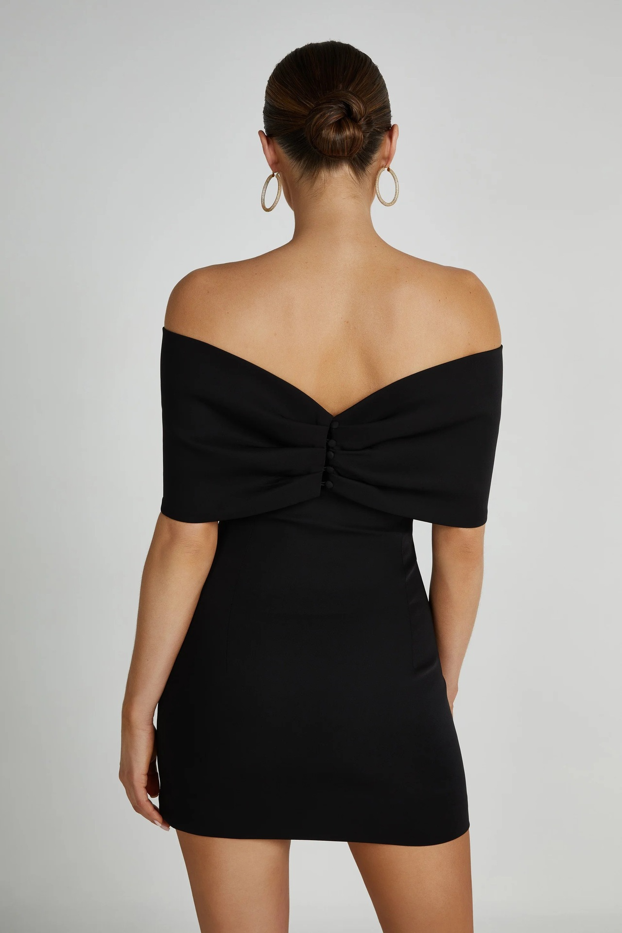 Black off-the-shoulder mini dress with bow detail