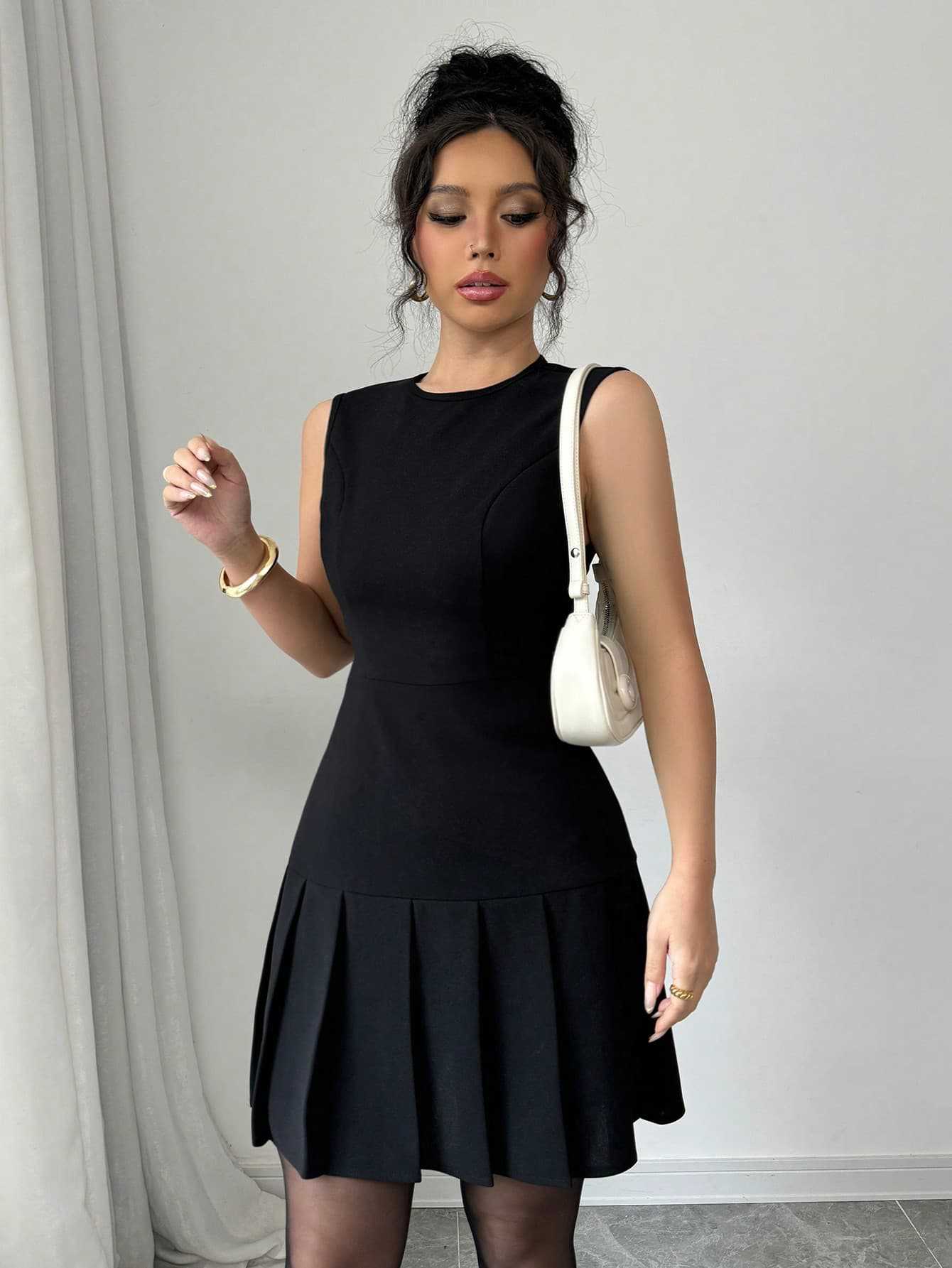 Black sleeveless mini dress with pleated skirt