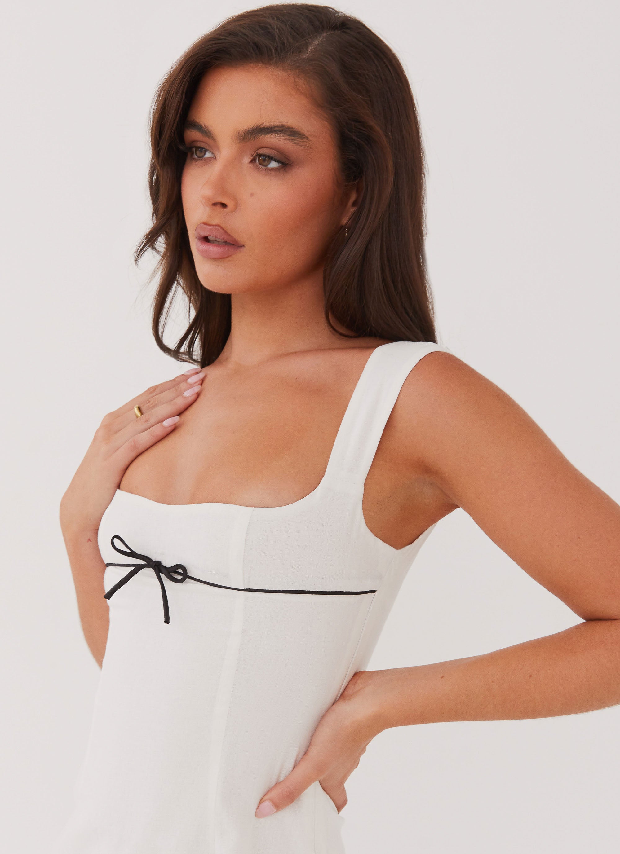 White mini dress with black bow detail