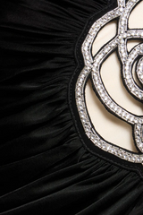 Black asymmetrical mini dress with pink appliqués and straps