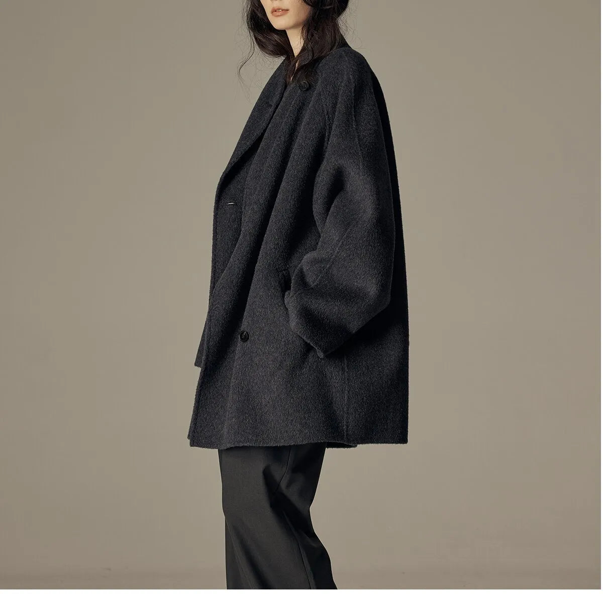 Oversized double-breasted coat with shawl collar.