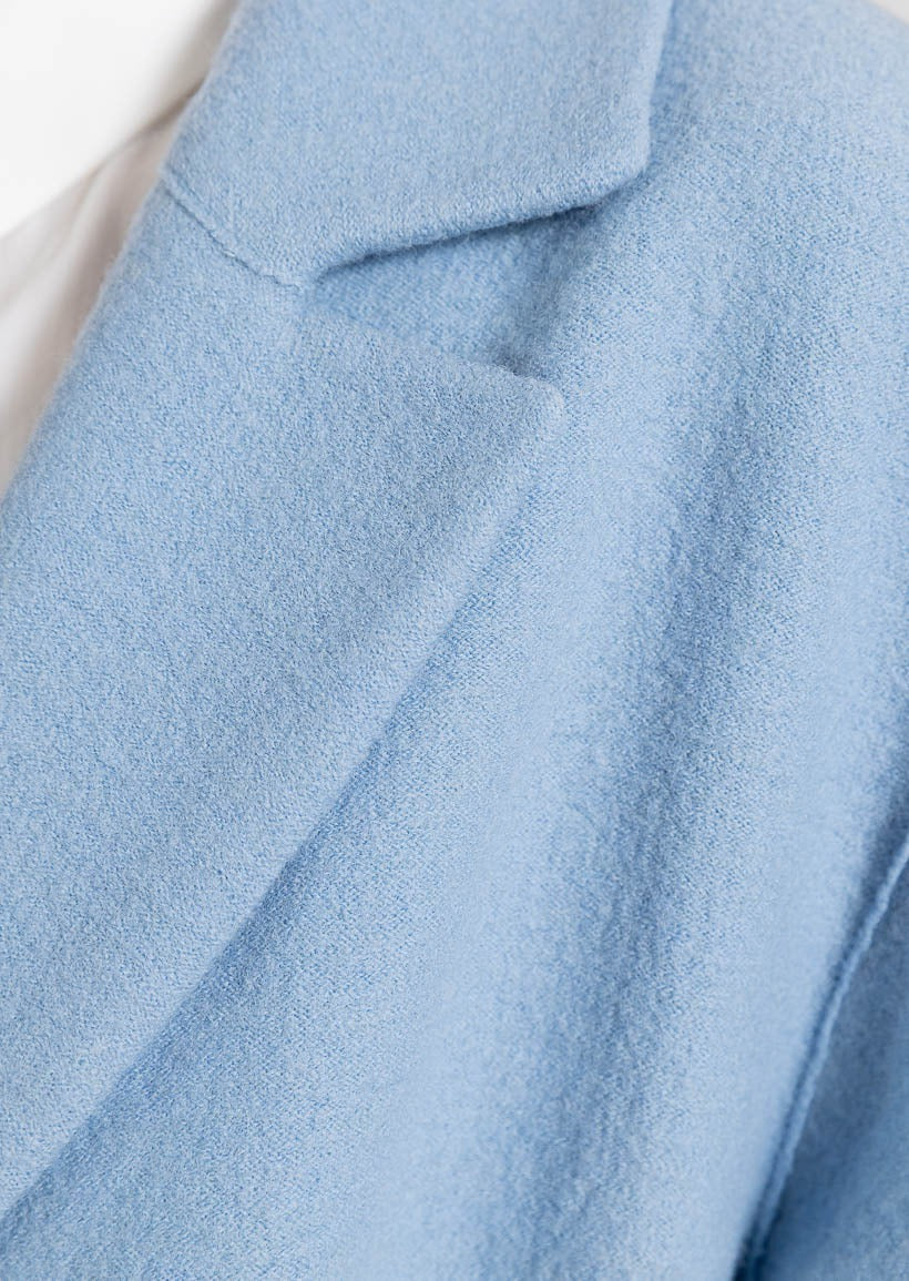 Light blue long coat with outside pockets