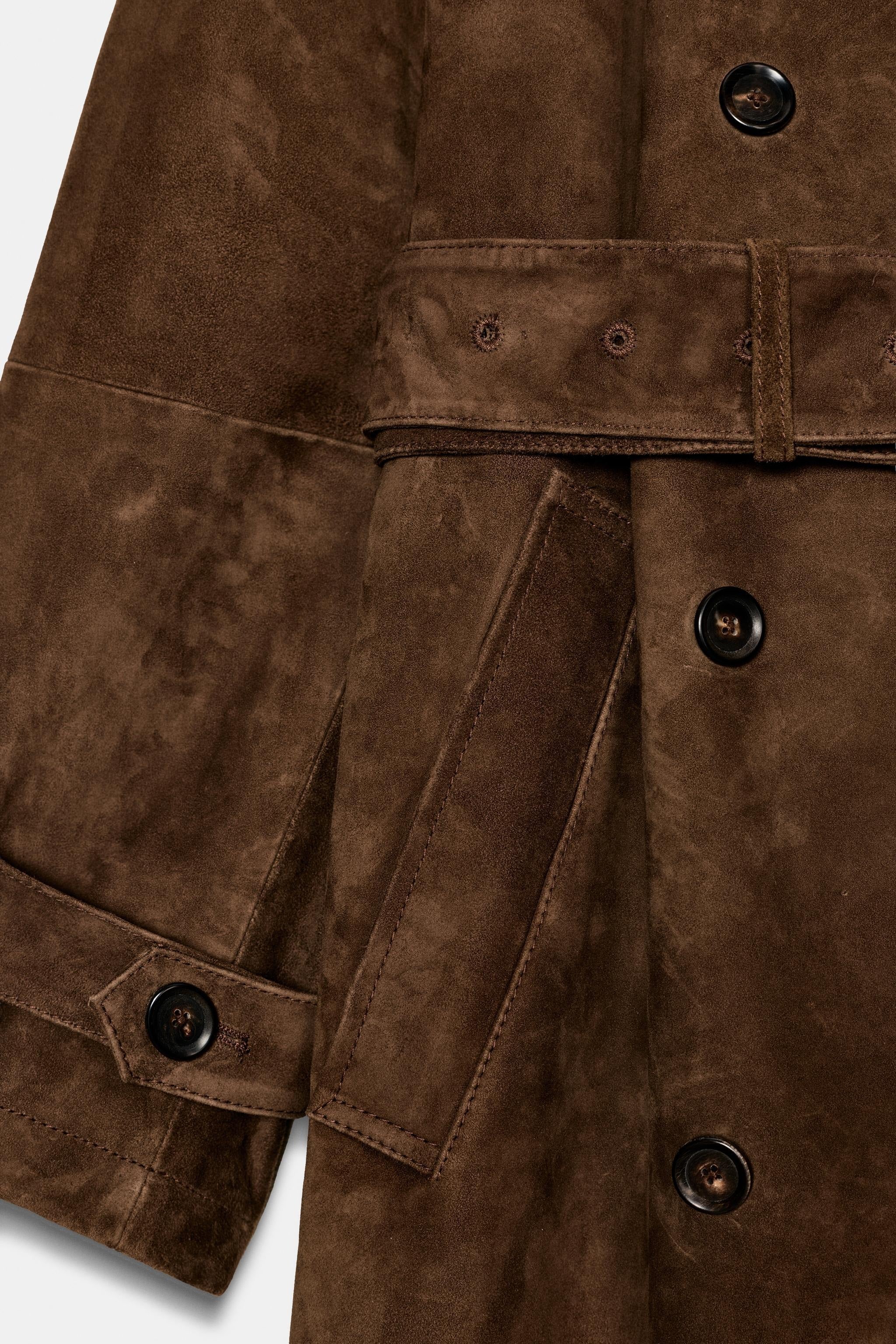 Brown trench coat with belt and shoulder details