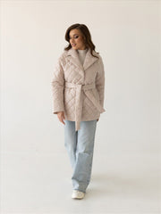 Beige quilted jacket with belt and shawl collar