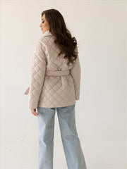 Beige quilted jacket with belt and shawl collar