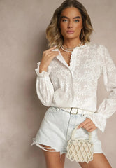 White embroidered blouse with ruffle trim at sleeves