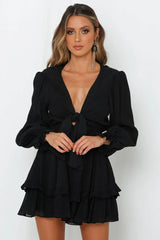 Black mini dress with bow closure and ruffles