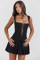 Black corset dress with lace and pleated skirt